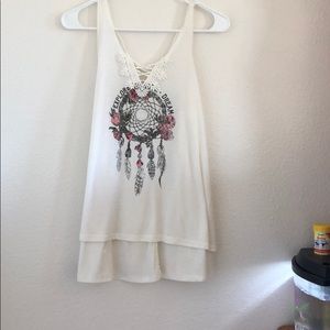 A loose “Explore your dreams” tank top